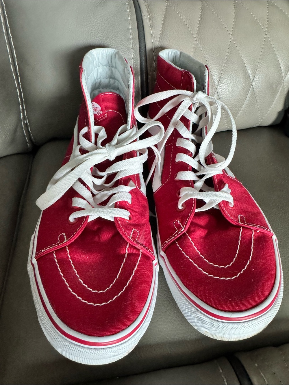 Men’s Vans Sk8-Hi high-top sneakers feature a vibrant red canvas